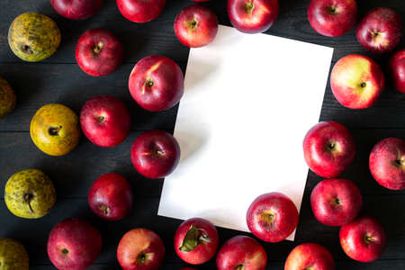 Imperfect red apples and yellow pears on a dark background. Bulk. Top view. Isolated. Seasonal apples. Russia, Chekhov.の写真素材