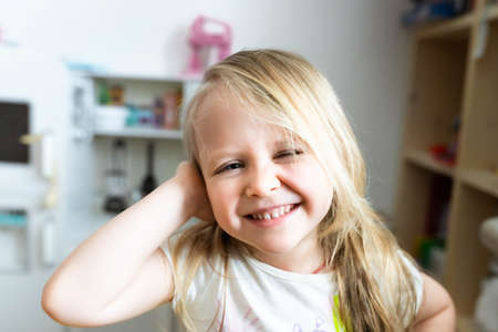 Portrait of a smiling little girl in the childrens room. Front view.の写真素材