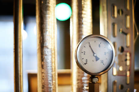 Equipment for the production of handicraft beer, a steam pressure gauge in a container jacket for saccharification of wort. Front view.の写真素材