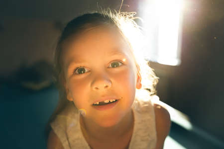 Portrait of a smiling little girl in the childrens room. Front view.の写真素材