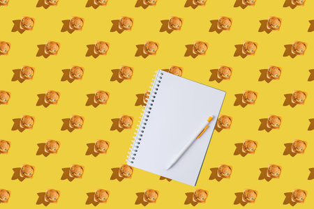 A pattern of muffins with notepad on a yellow background. Flat lay. Place for text, copy space.