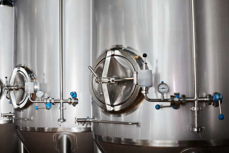 Equipment for the production of craft beer, containers for fermentation in the climatic chamber, pressure gauge with tubes and stainless steel tanks.の写真素材