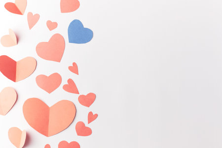 Valentines Day. Red and blue heart made of paper on a white background. Top view. Copy space. Place...