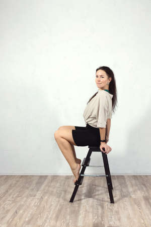 Fitness, pilates, sports, gymnastics, exercise, healthy lifestyle concept. An attractive woman does exercises in the gym. Front view. Vertical photo.の写真素材