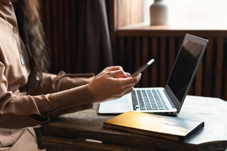 Attractive business woman with a laptop in the office at work. The concept of remote work, work for...