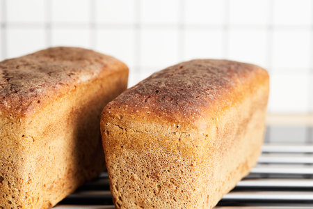 The process of making rye bread. The finished bread is taken out of the oven. Front view.