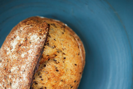 Homemade wheat bread with flax seeds. The concept of homemade bread and healthy food. Top view. Flat lay.の写真素材