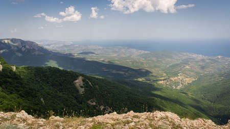 Panorama in a mountainous area in summer. Landscape with mountains, hills and cliffs. Front view.の写真素材