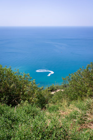 Seascape, rocks and greenery, the southern sea. A ship on the water. Recreation concept on the sea....