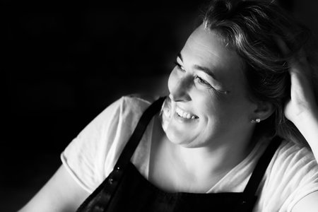 Black and white portrait of an attractive smiling woman. The concept of living in pleasure. Front...