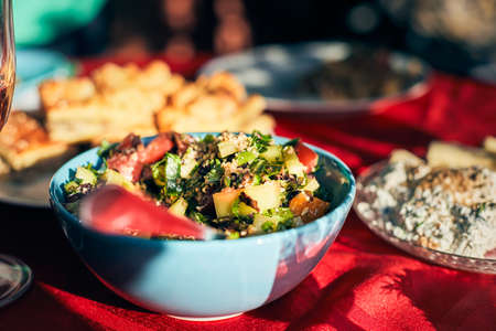 A bowl of snacks on the table. Vegetables and grits in a salad. Front view.の写真素材