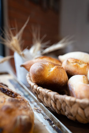 Ready-made La Ciriola romana bread on the counter at the artisan bakery. Vertical photo.