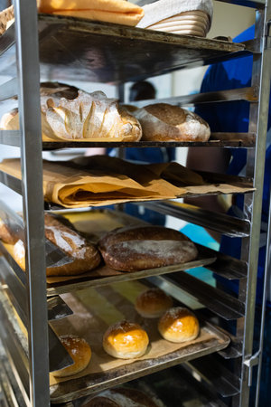 Artisan bread on the counter in the bakery. The process of making bread. Vertical photo.