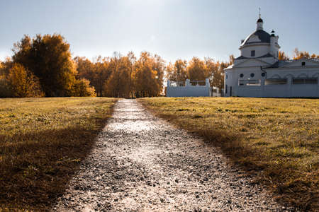Autumn landscape, the road and the Orthodox Church. Russia, Konstantinovo. Front view.の写真素材