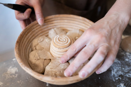 The process of making traditional French bread in a craft bakery. Molding of the Bordeaux crown....