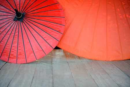 Red umbrella on a wooden floorの写真素材