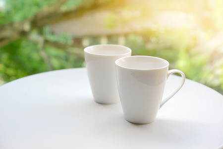 Two cup, of tea or coffee on table garden bright backgroundの写真素材