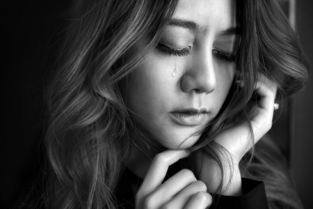 Beautiful young woman lonely, Close up her eyes and cry about the past depressed, In black and white concept person fear sadness.の写真素材