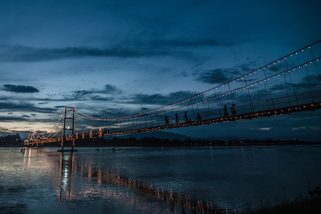 Beautiful sunset 200 Years Celebration Rattanakosin suspension bridge over the River Ping.Tak Thailandの写真素材
