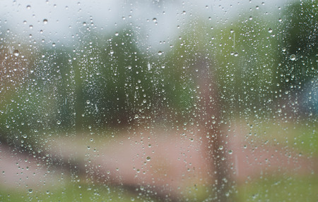 Rain water drops on a glass surface background, Abstract Backdropの写真素材