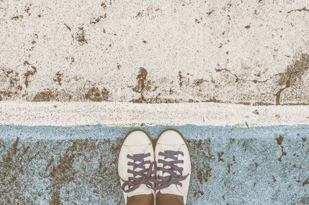 Pair of shoes standing from sports floorの写真素材