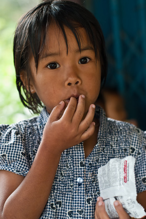 CHIANG MAI THAILAND - OCTOBER 23 : unidentified children eat snacks in their village on OCTOBER 23, 2009 in CHIANG MAI, THAILANDのeditorial素材