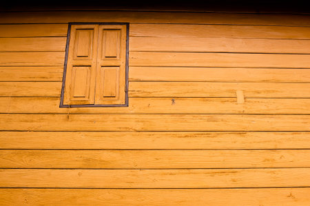The external wood window and wall of a vintage wood house