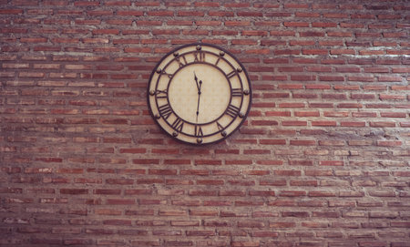 vintage clock on brick wall backgroundの写真素材