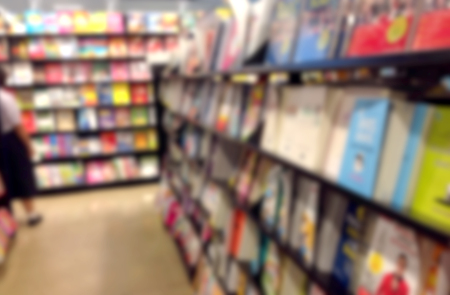 Blur abstract background of book on bookshelves in bookstore. Blurry view library with literatureの写真素材