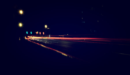 Blurry Illumination and night lights, car traffic motion blur the speed and dynamics
