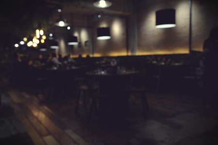 Coffee shop blur background with bokeh light with vintage filterの写真素材