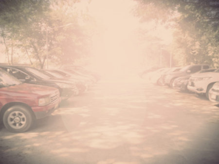 Blured image of cars in parking lot on day time