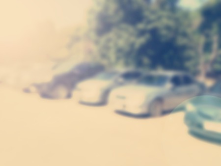 Blured image of cars in parking lot on day timeの写真素材