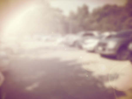 Blured image of cars in parking lot on day timeの写真素材