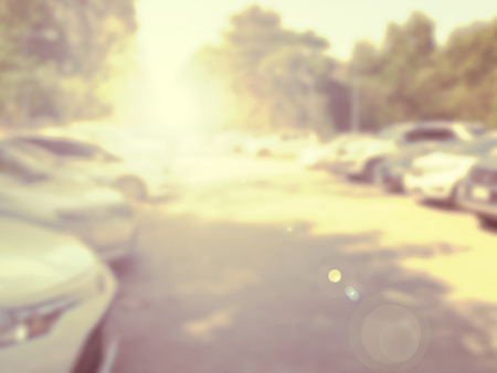 Blured image of cars in parking lot on day timeの写真素材