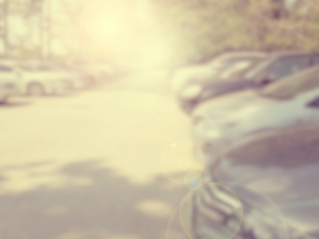 Blured image of cars in parking lot on day timeの写真素材