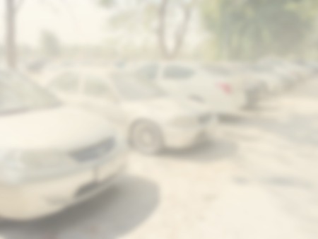 Blured image of cars in parking lot on day timeの写真素材