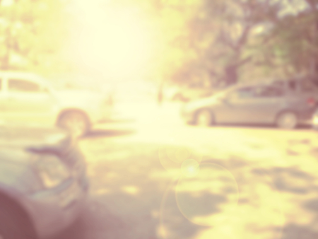 Blured image of cars in parking lot on day timeの写真素材