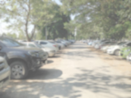 Blured image of cars in parking lot on day time