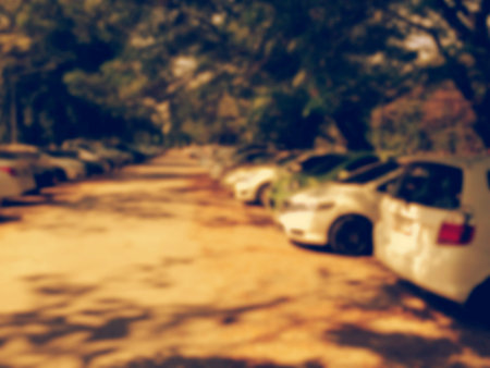 Blured image of cars in parking lot on day timeの写真素材