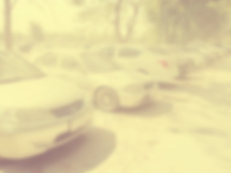 Blured image of cars in parking lot on day timeの写真素材