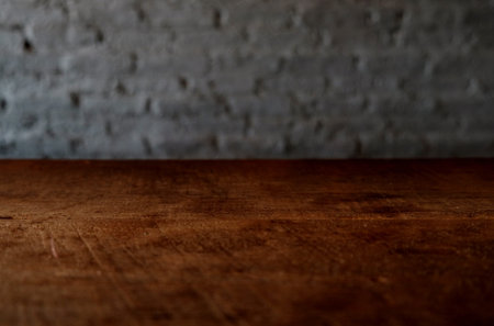 Empty top of wooden table or counter isolated on rustic focus wall brick Texture background. For...
