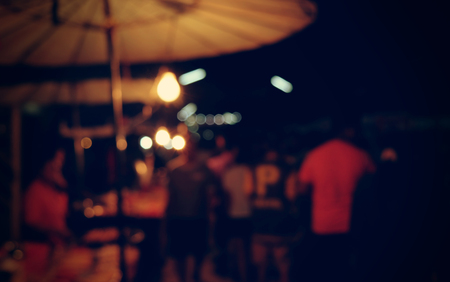 vintage tone blur image of food stall at night festivalの写真素材