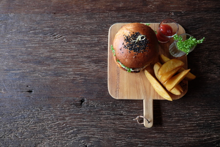 Delicious fresh homemade burger on a wooden tableの写真素材