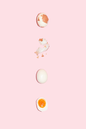 Peeled egg on a pink background. Creative composition. Flat lay. Easter 2021.の写真素材