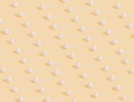 Creative pattern made with a white spoon and Easter eggs. Beautiful pastel background. Lay out the mini concept. 2021の写真素材