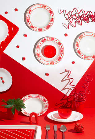 New Year's table decoration with red and white plates. Creative holiday composition. Christmas 2022の写真素材