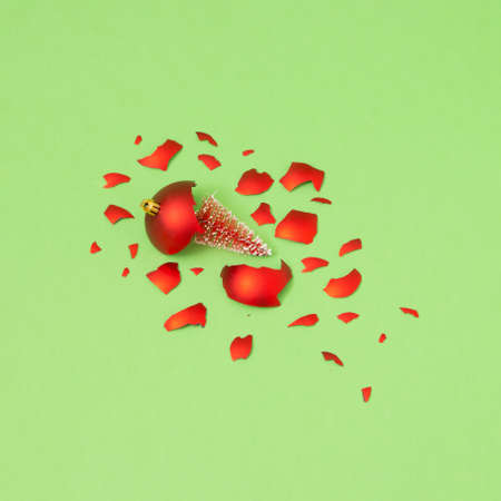 Pattern of red Christmas decorations with one broken on a pastel background. Minimal New Year decoration concept. Creative idea background. 2022の写真素材