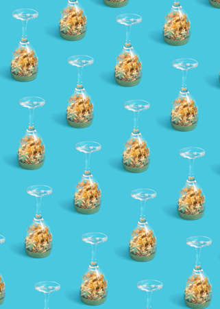 Pattern of upside-down glasses with yellow stars, on a pastel blue background. Xmas minimal composition. 2022の写真素材