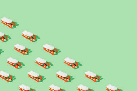 Pattern of red Christmas sleighs on a green background. Xmas 2022.の写真素材